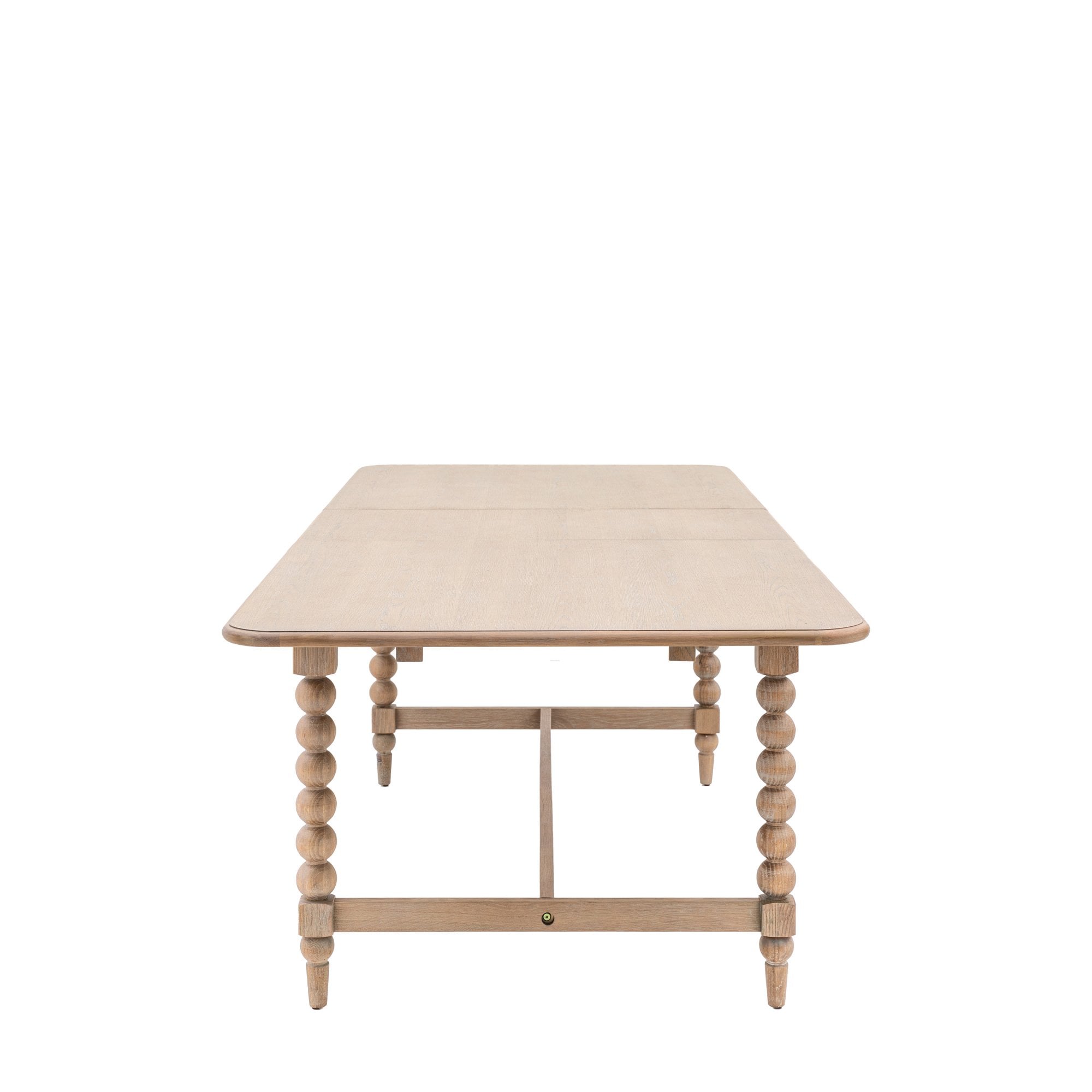 A light wood dining table with bobbin legs on a white background, viewed from above.