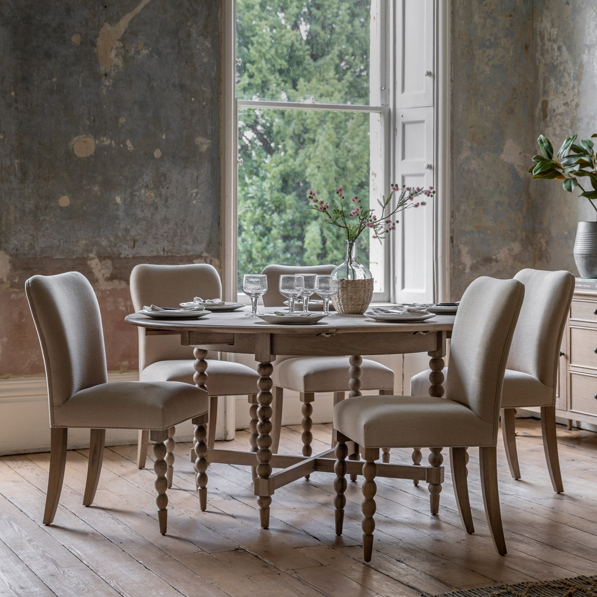 Dining room with an oval dining table and four upholstered chairs.