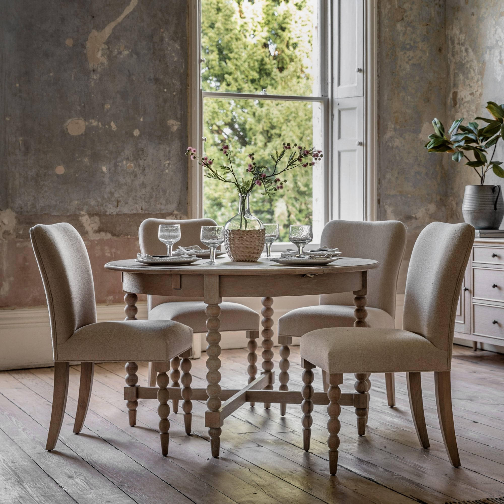 Dining room with an oval dining table and four upholstered chairs.