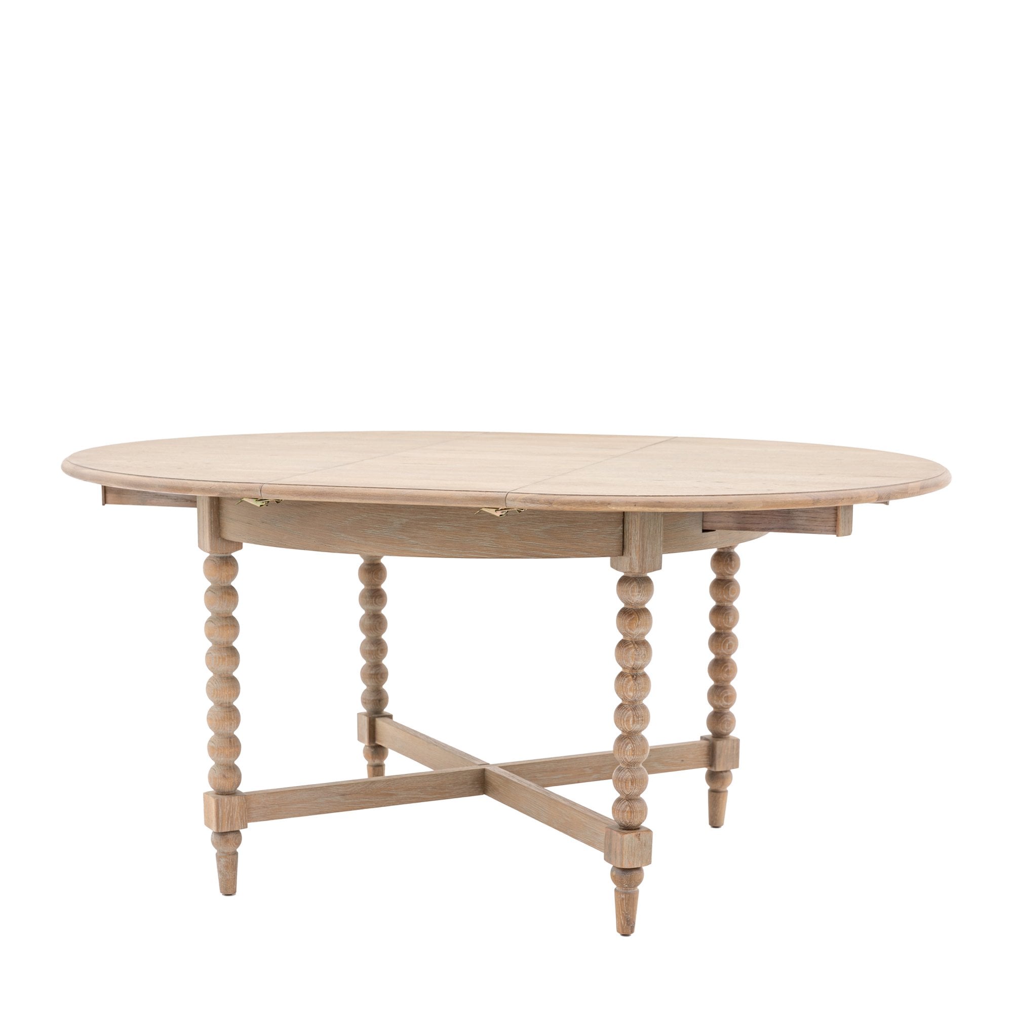 An oval light wood dining table with two leaves extended.
