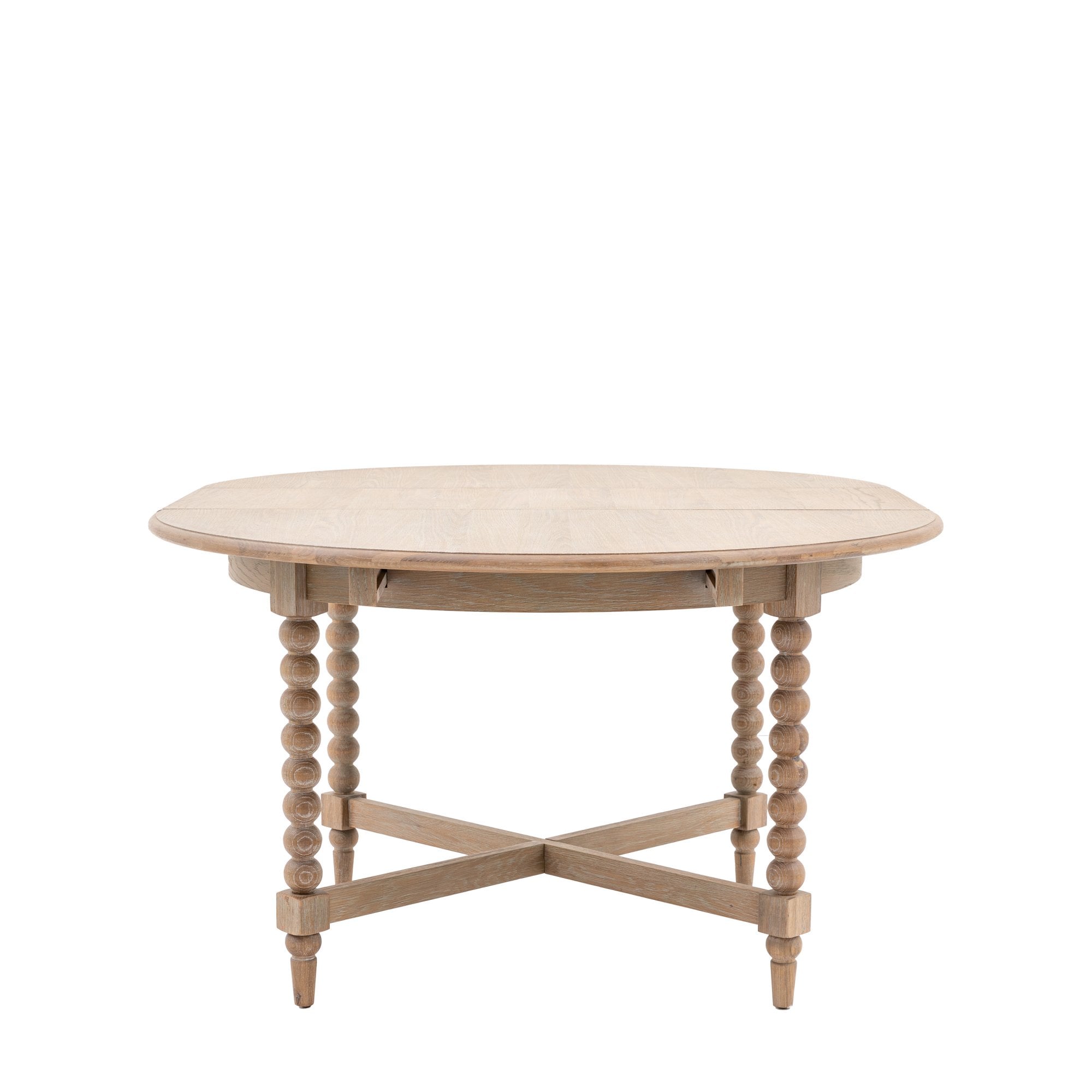 An oval light wood dining table with the two leaves folded down.