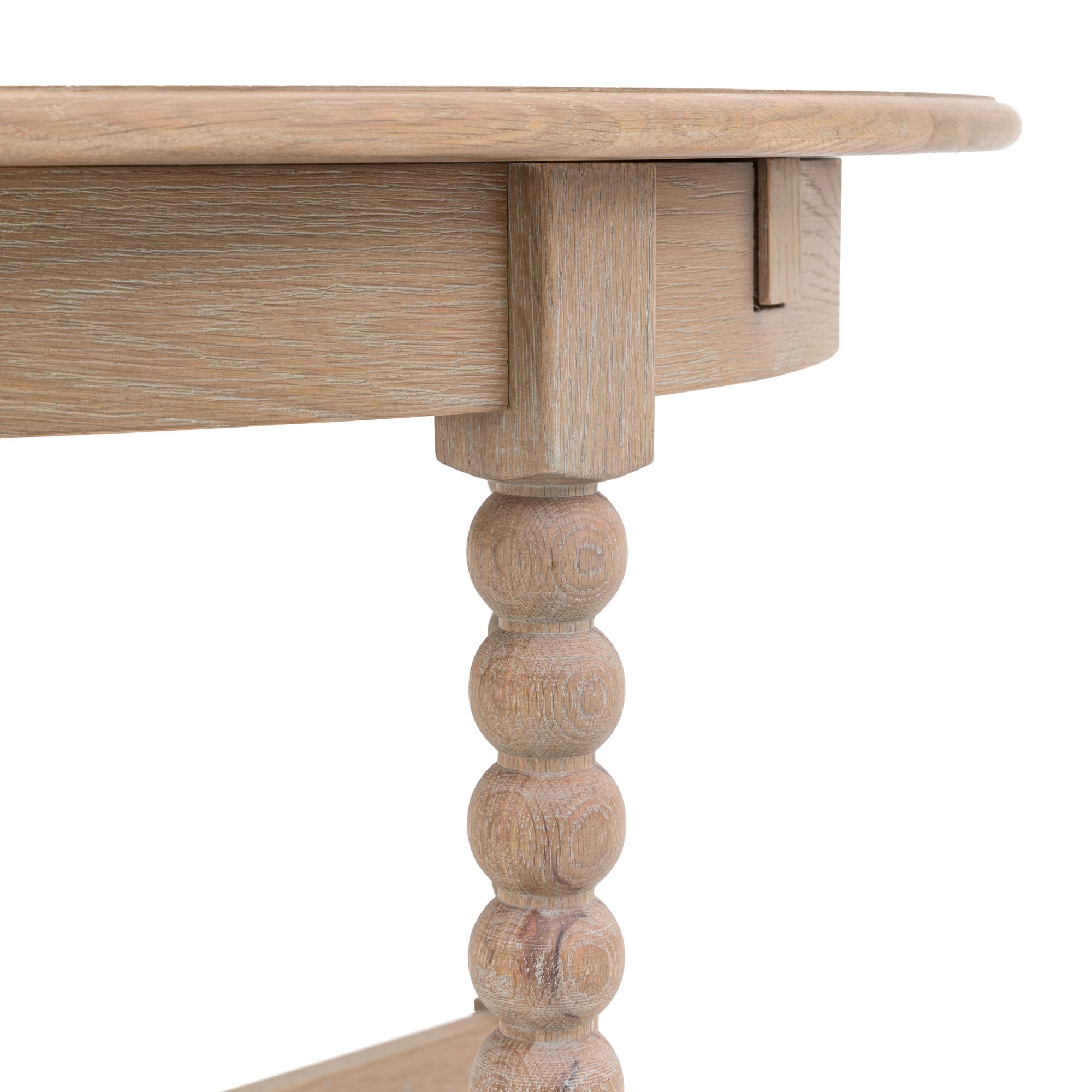 Close-up of the light wood dining table with a folded leaf.