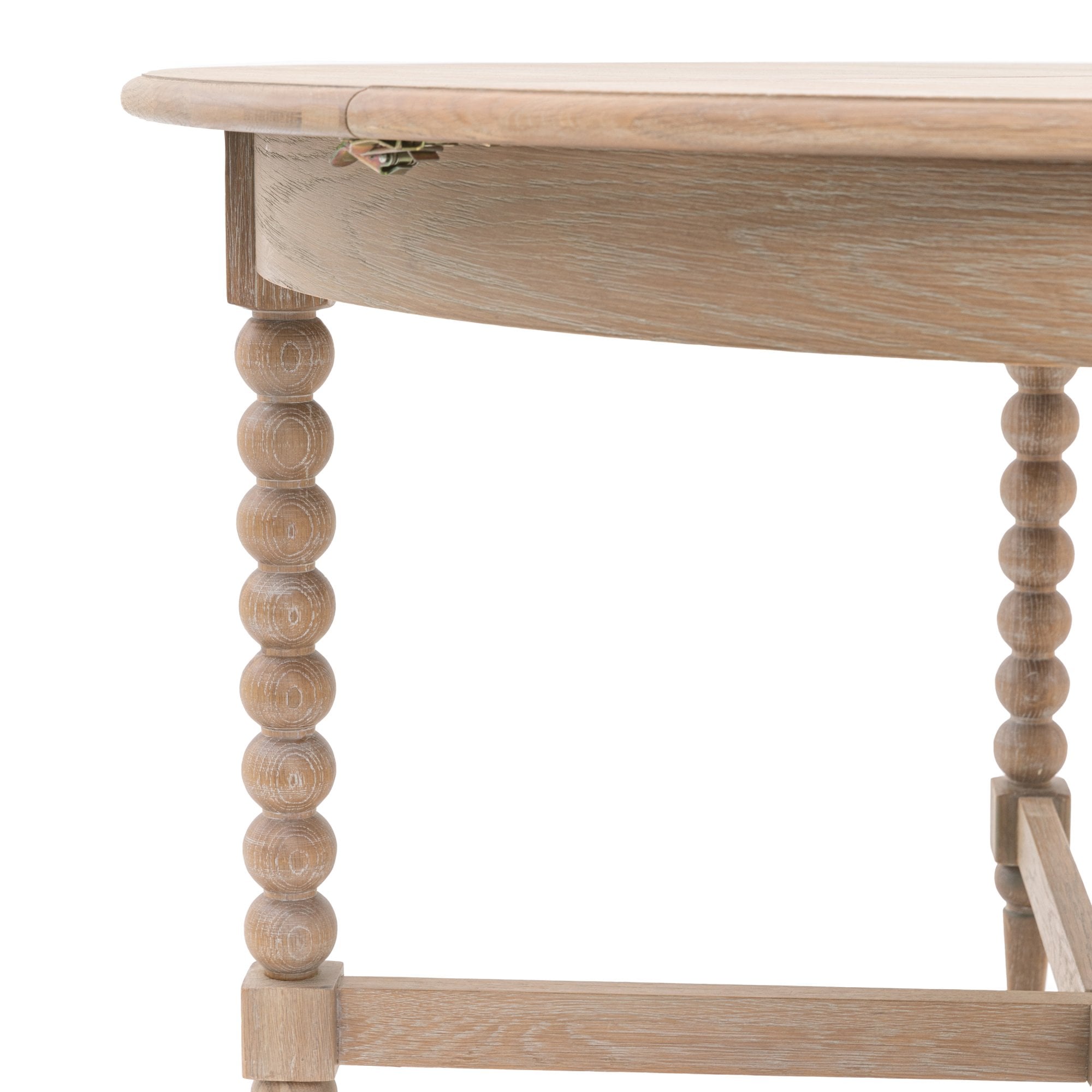 Close-up of the light wood dining table with a folded leaf mechanism.