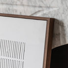 A close up of a framed piece of white wall decor.