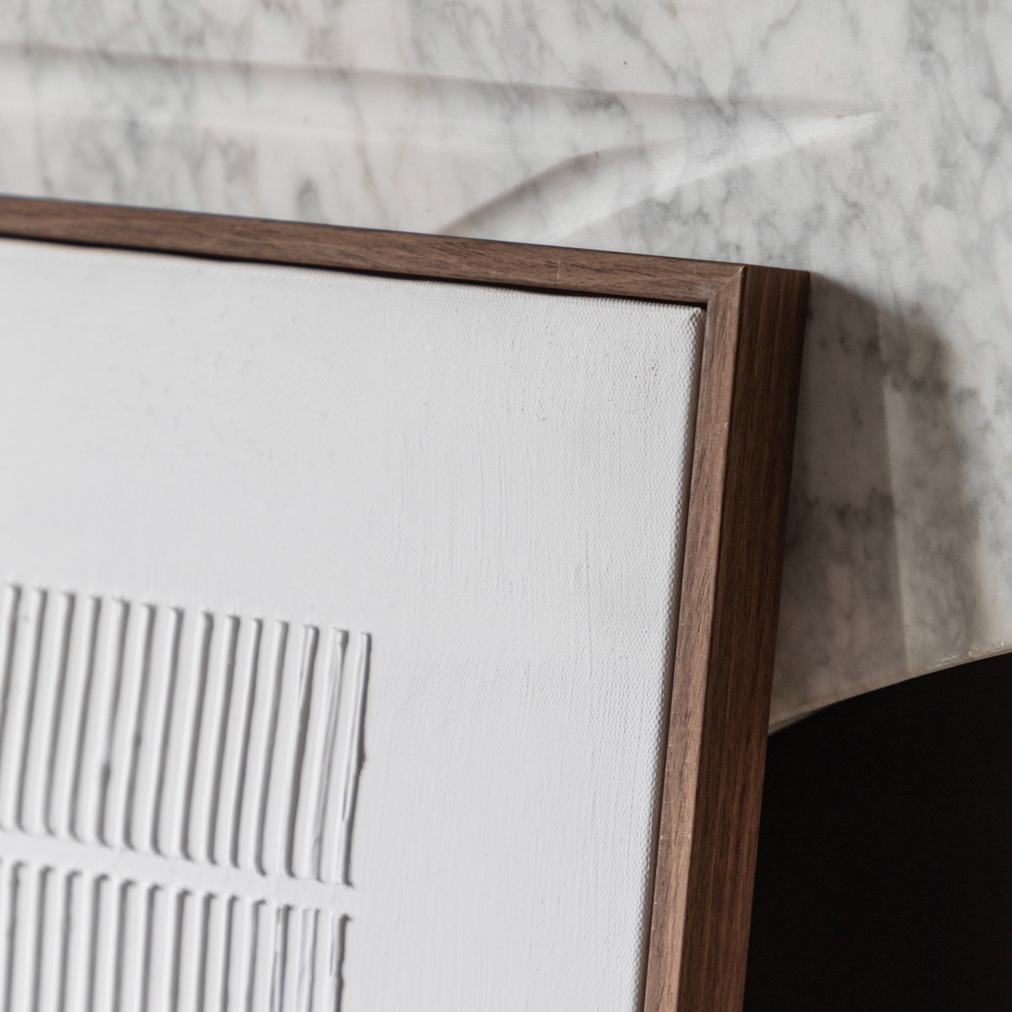 A close up of a framed piece of white wall decor.