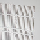 A close up of the grooves on the framed wall decor.