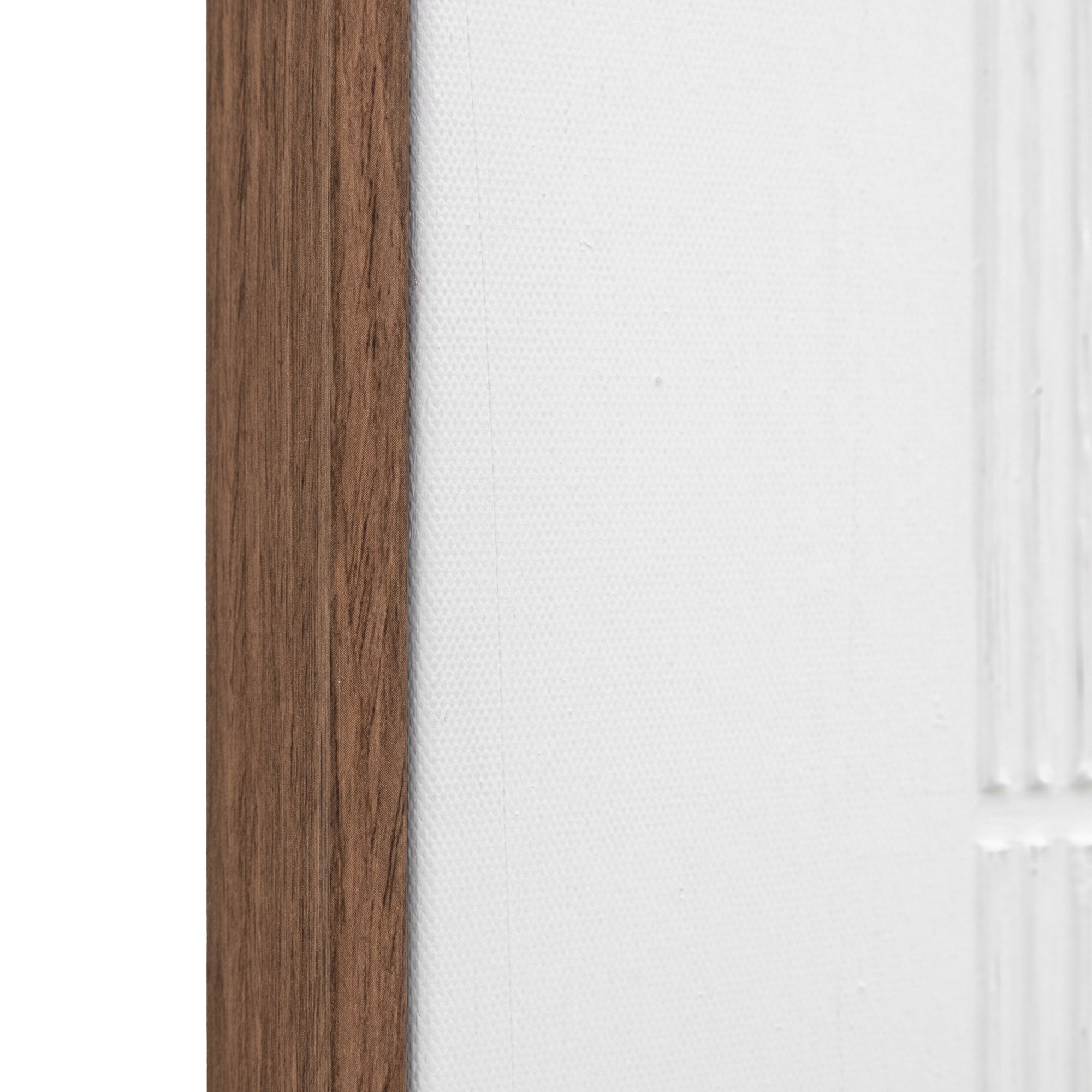 A close up of the corner of the framed wall decor.