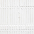 A close up of the white and textured wall decor.