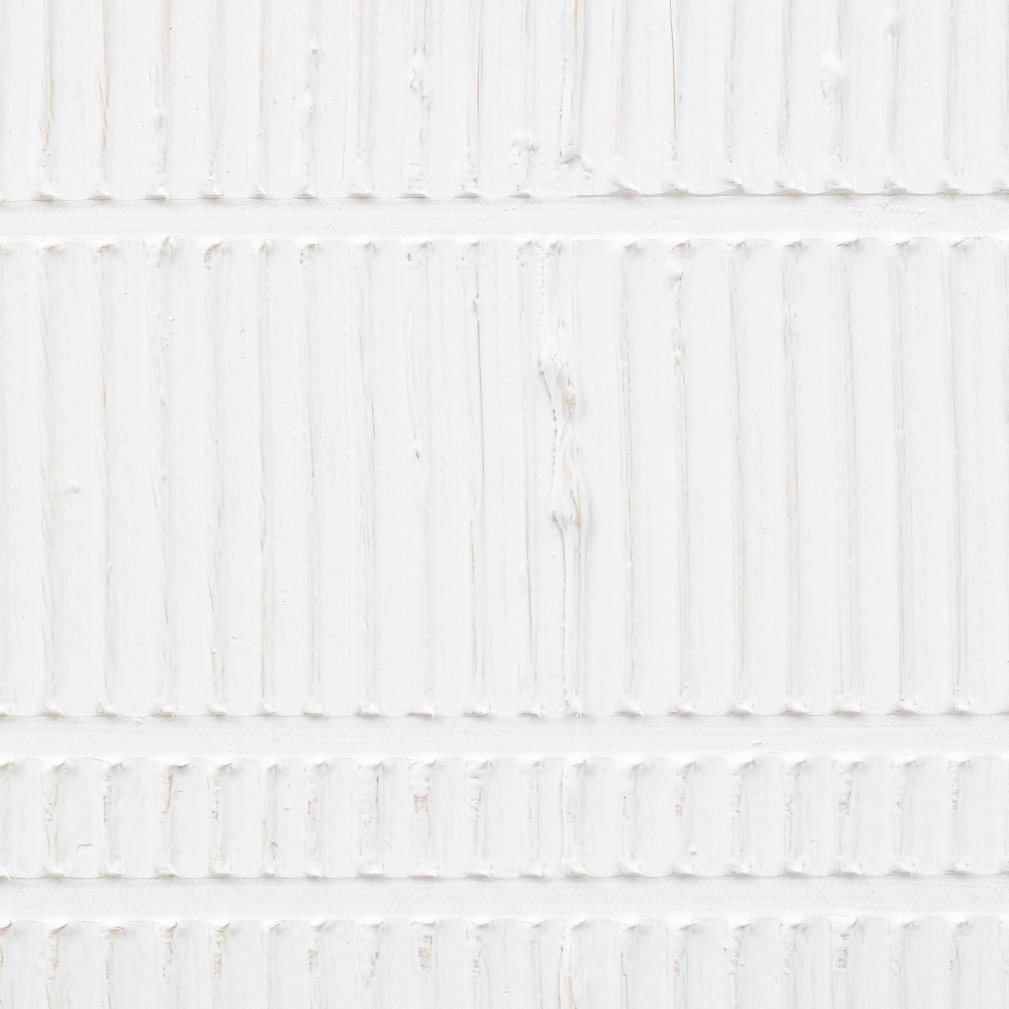 A close up of the white and textured wall decor.
