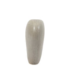A tall, slender, light grey, stone-like decorative vase, with a smooth and organic shape.