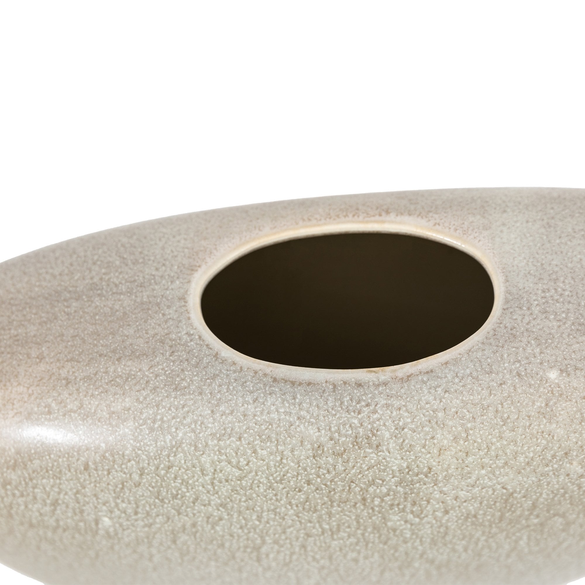 A close up of the opening of a light grey, stone-like decorative vase, showing its texture.