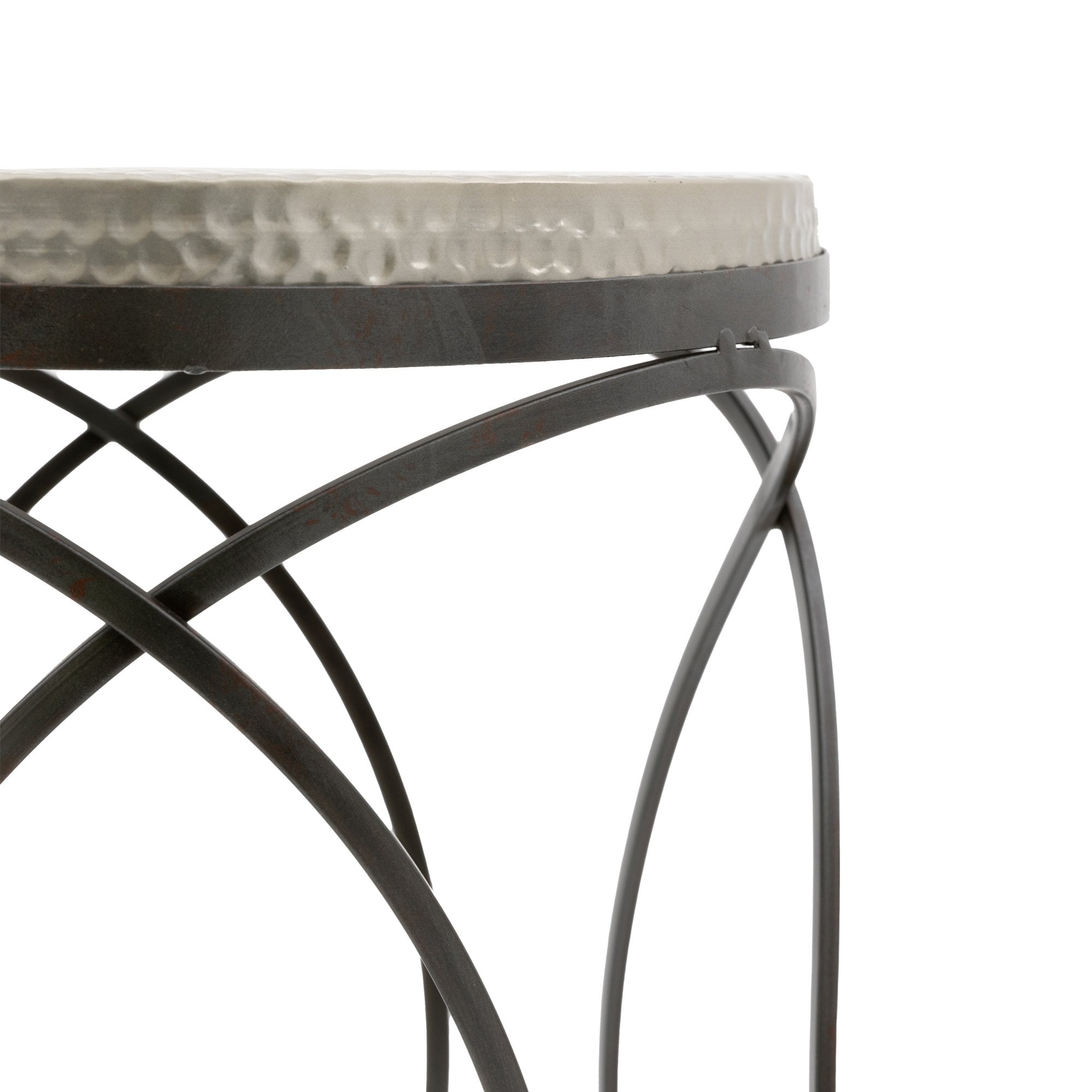 Close-up of the hammered metal top and black metal geometric base of a round side table.
