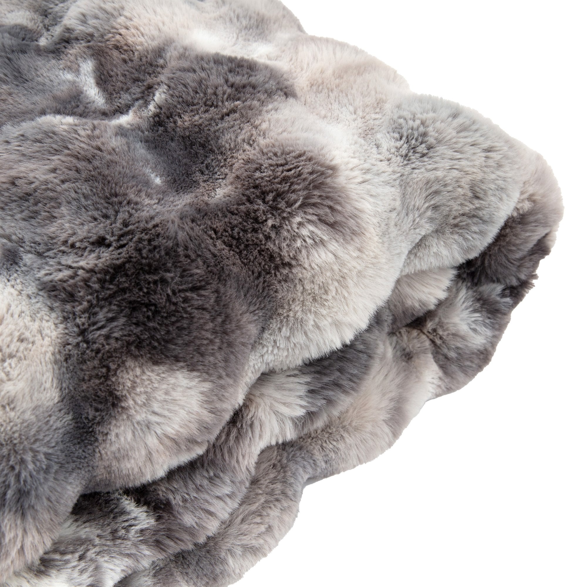 Folded faux fur blanket, emphasizing its thickness and soft appearance.