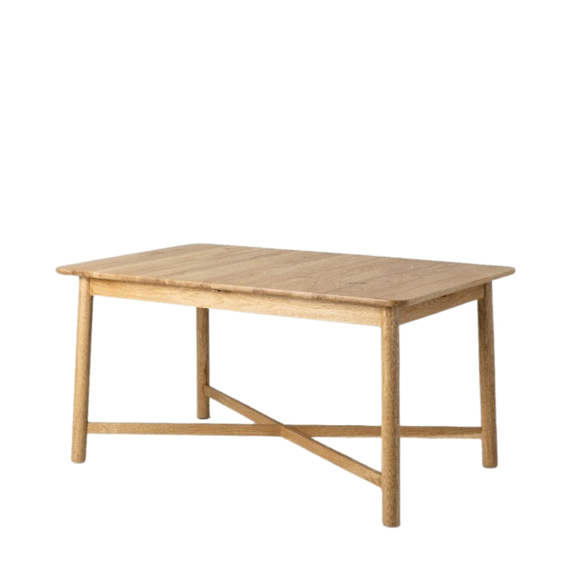 Angled view of a rectangular light wood dining table with an X-shaped base.