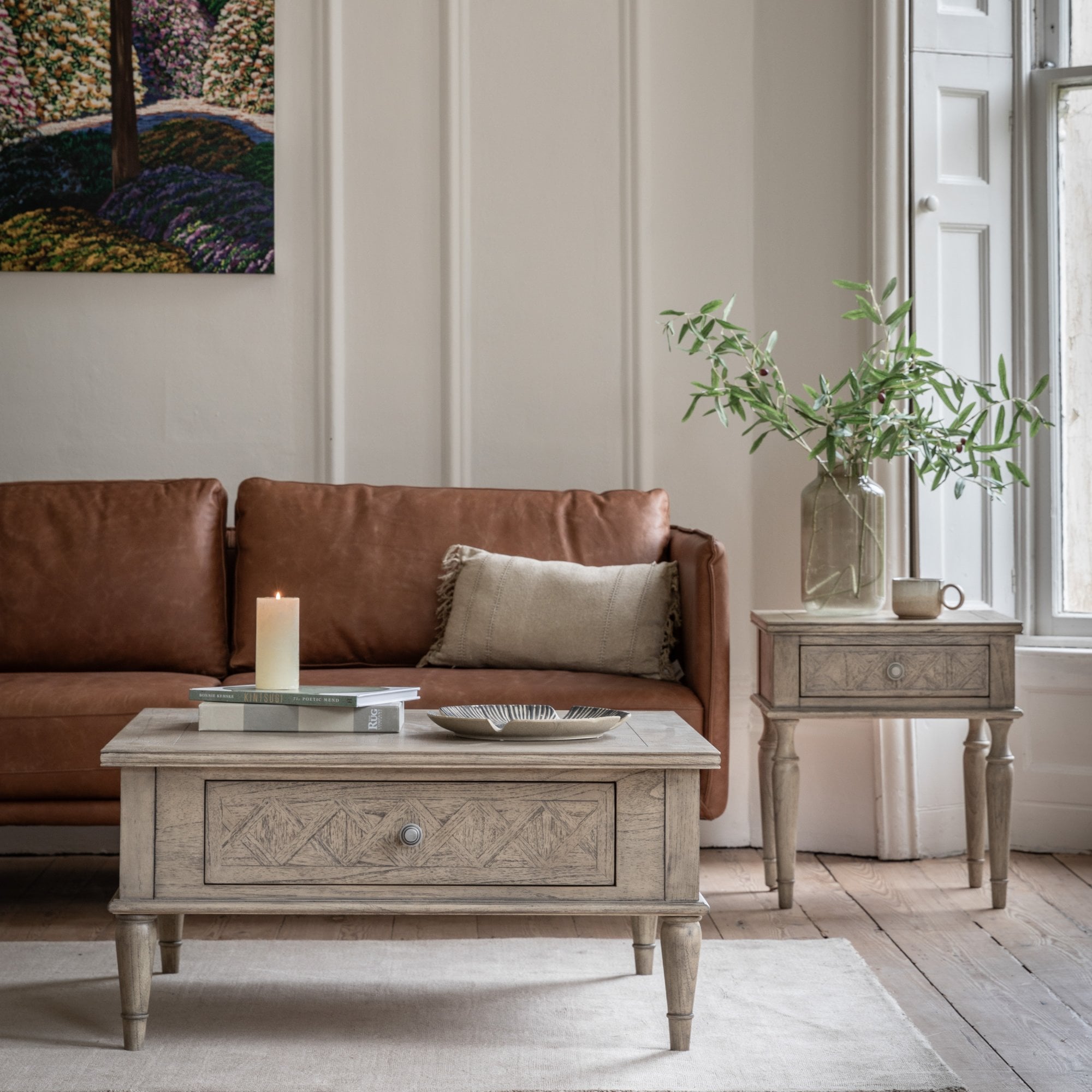 Living room scene with matching distressed grey coffee table and bedside table.
