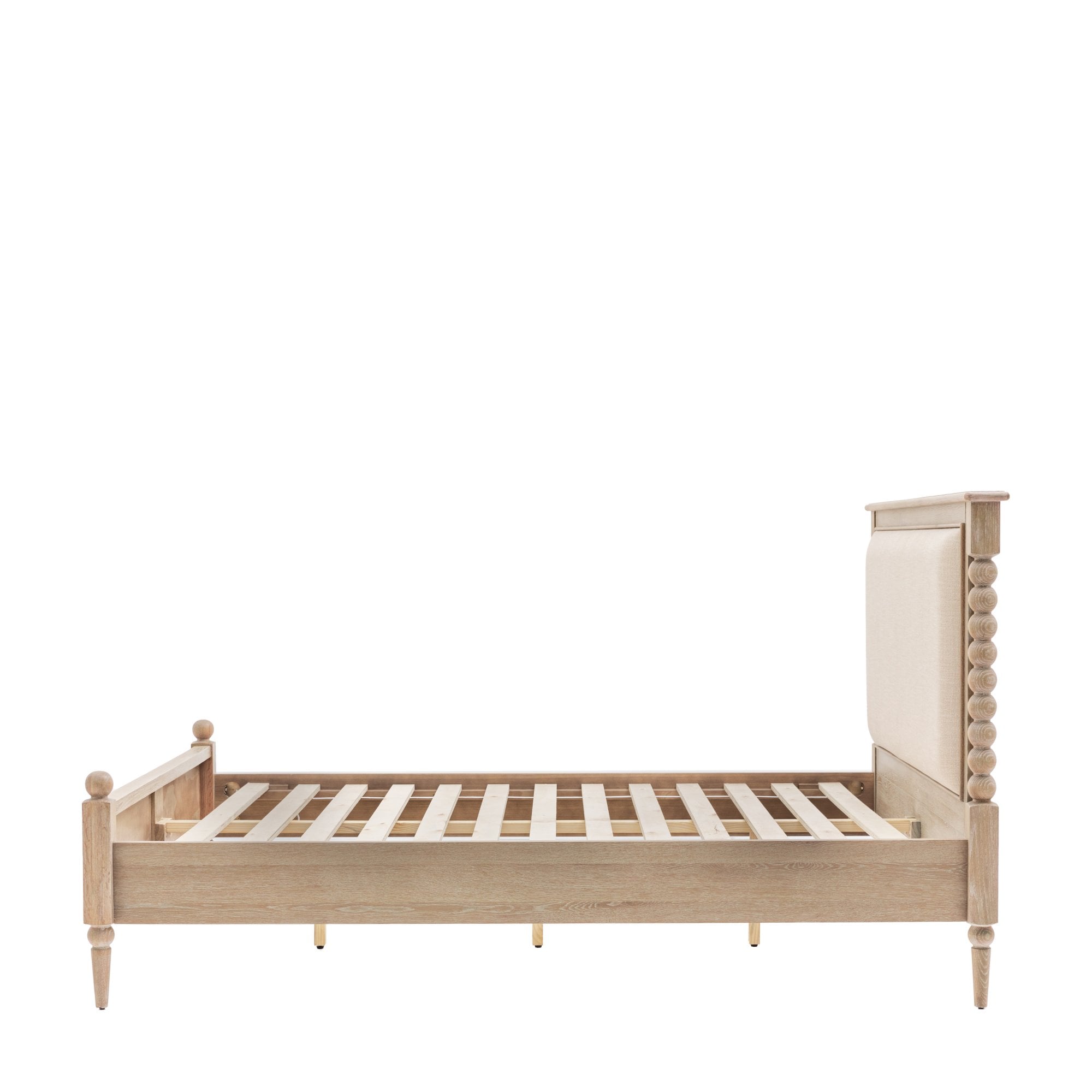 A side view of a light wood bed frame with an upholstered headboard.