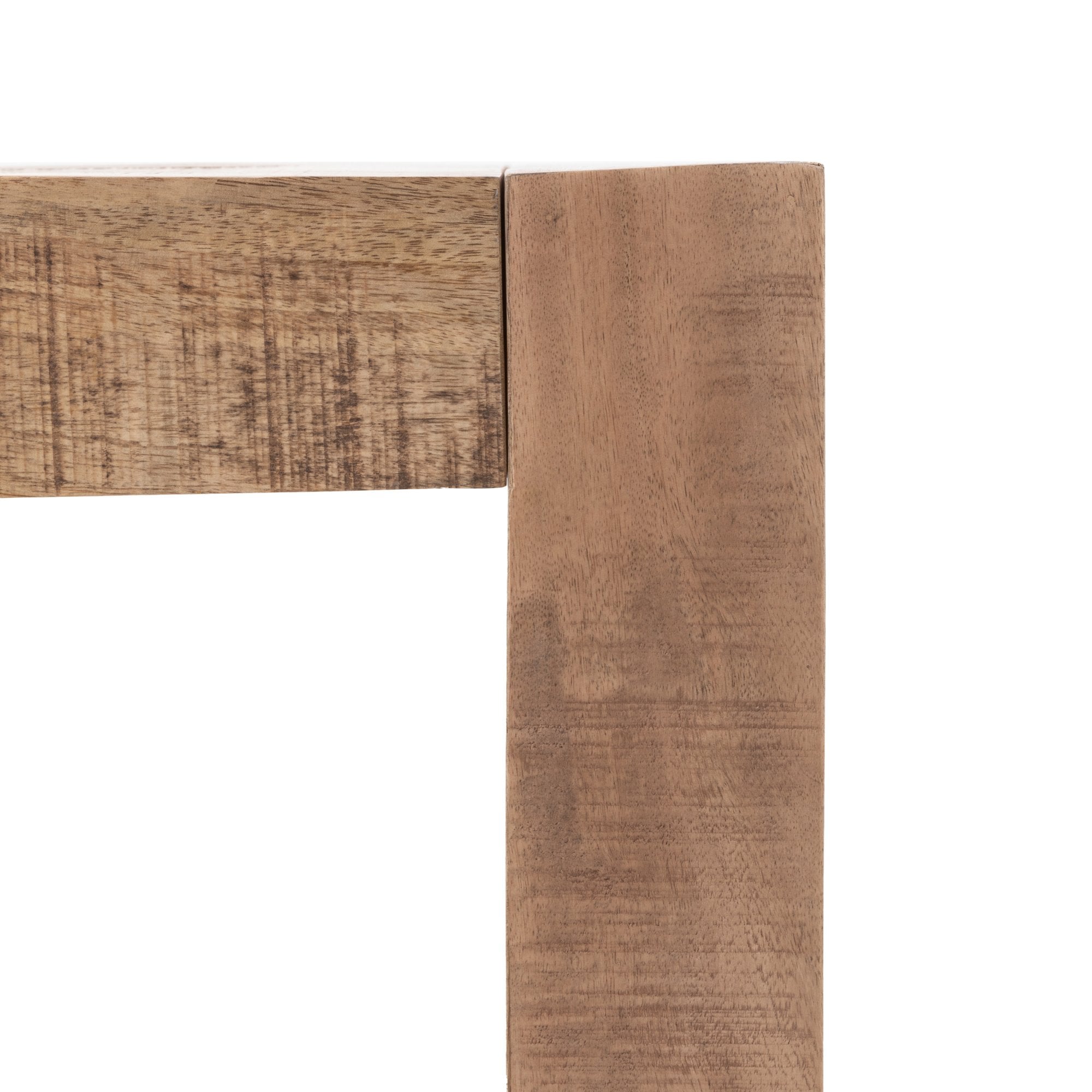 Close-up of the corner joint of a wooden table, showing the wood grain.