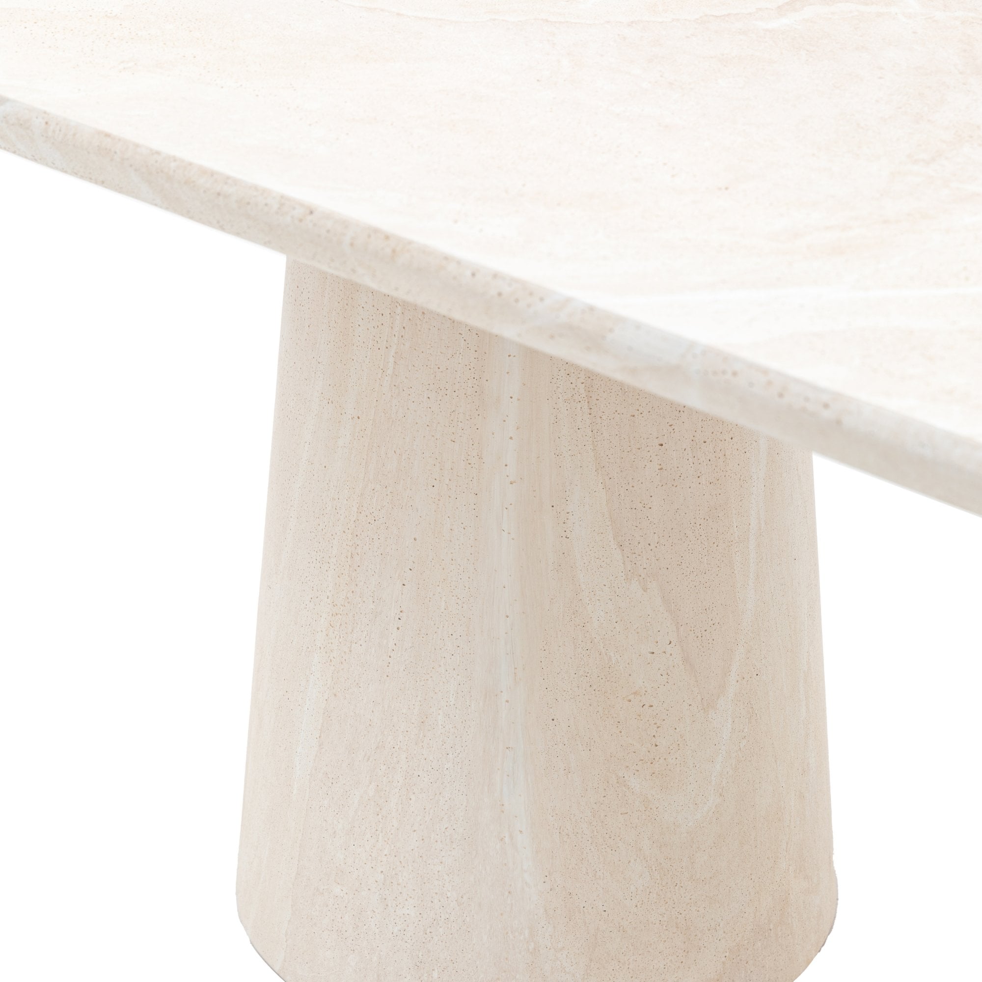 Close-up of the square corner of a light beige stone tabletop with a conical base.