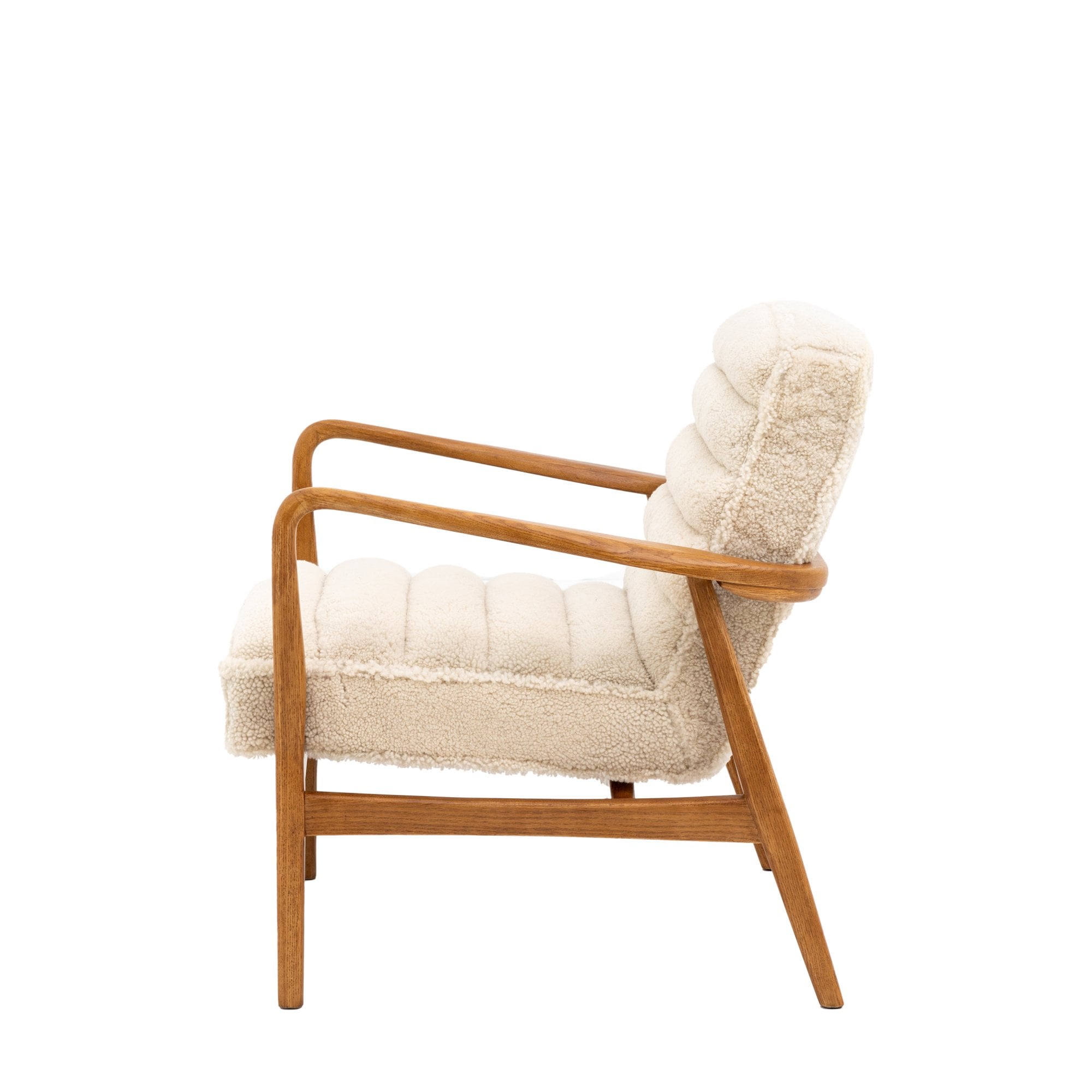 Side view of a cream-colored armchair with a curved wood frame.
