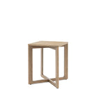 Angled view of a light wooden square side table with a distinctive cross-shaped base.