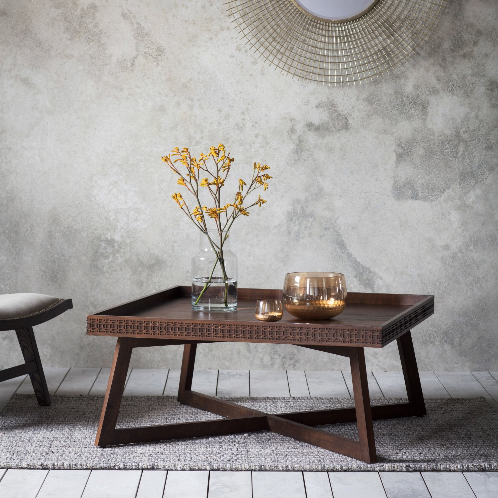 Boho coffee table with flowers and candles.