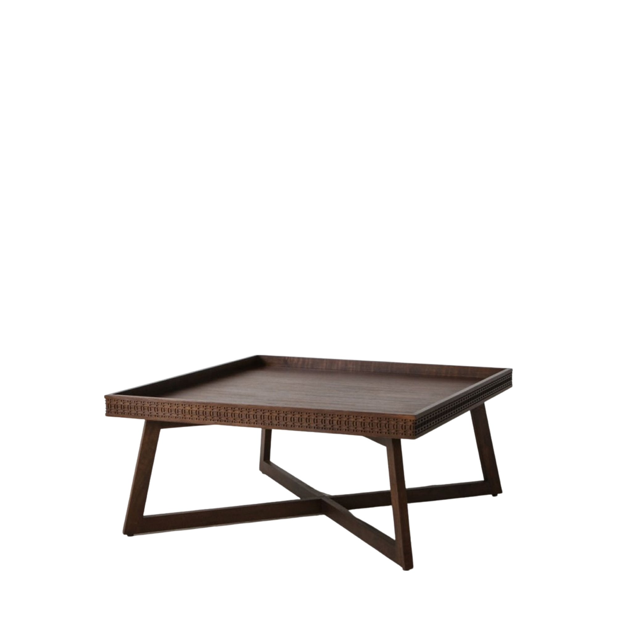 A wooden coffee table with a carved pattern, angled view.