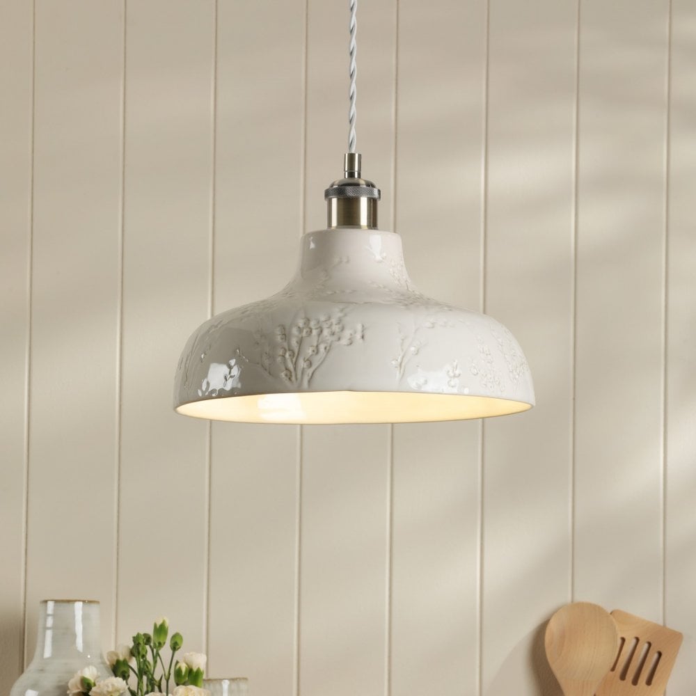A white pendant light with a textured surface hangs from the ceiling, illuminating the space.