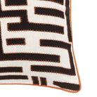Detailed close-up of the woven black and white pattern of a pillow with orange stitching.