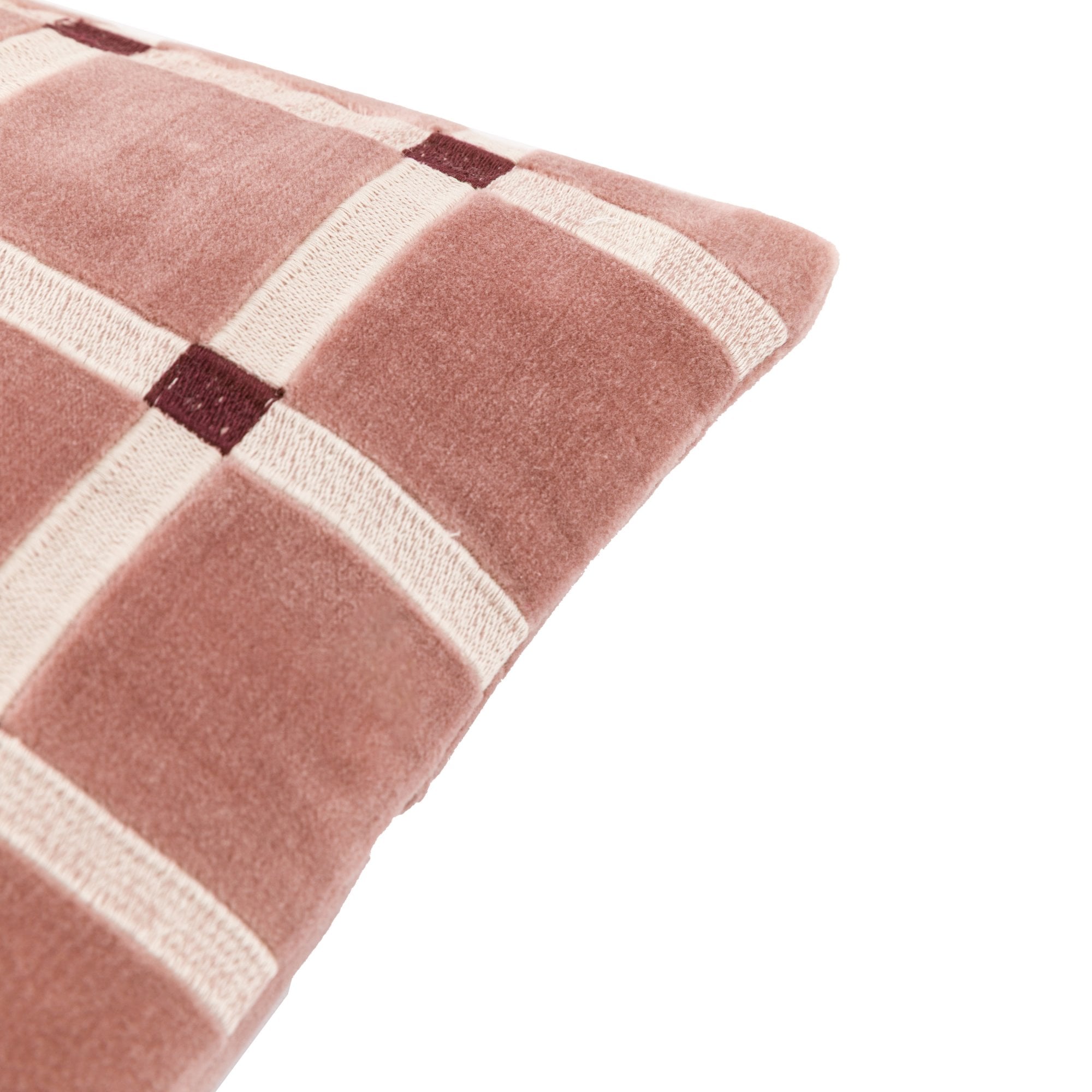 Diagonal close-up of the pink lumbar pillow showing the pattern.
