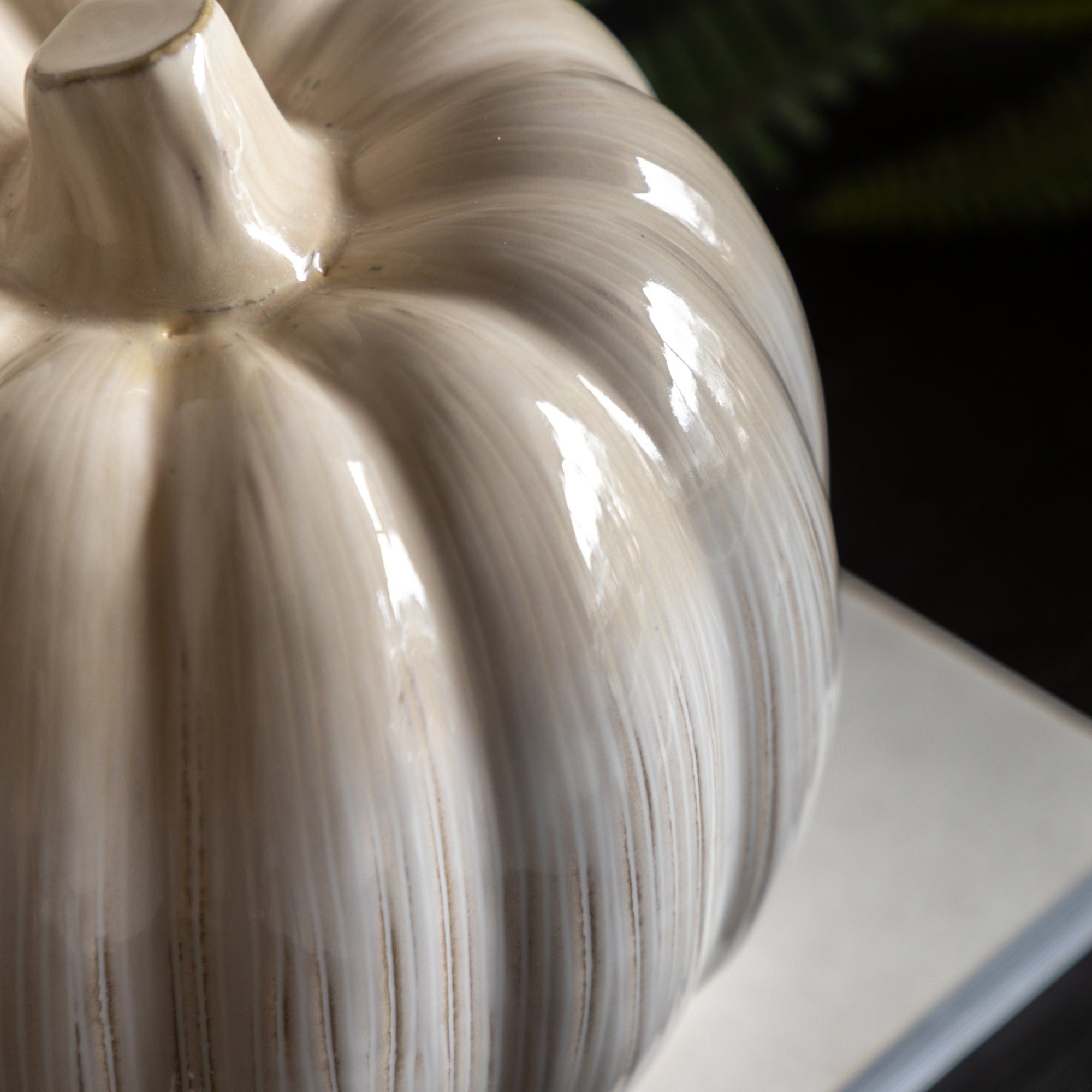 Close-up of the textured, shiny surface of the decorative pumpkin.