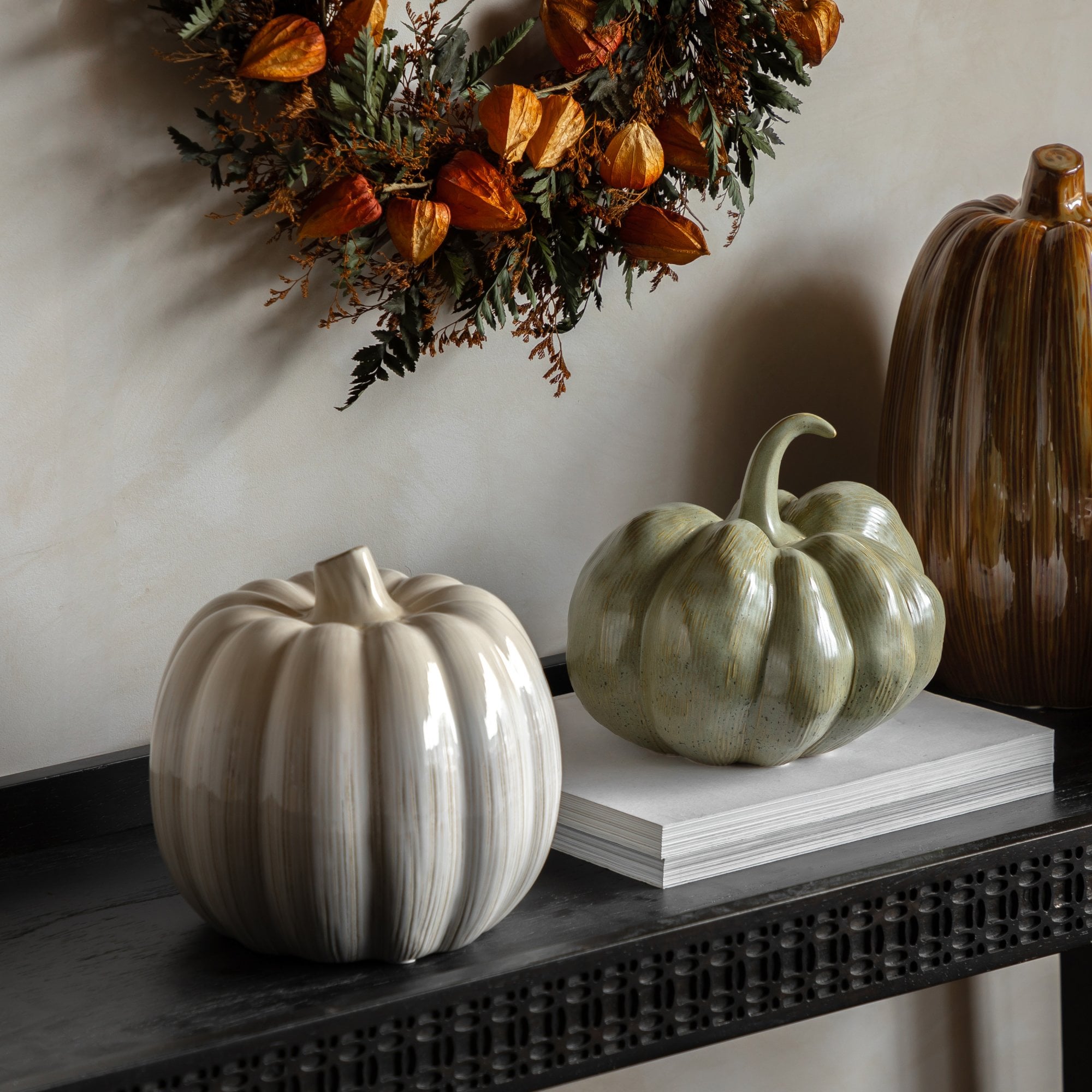 A collection of decorative pumpkins on a console table, perfect for autumn styling.