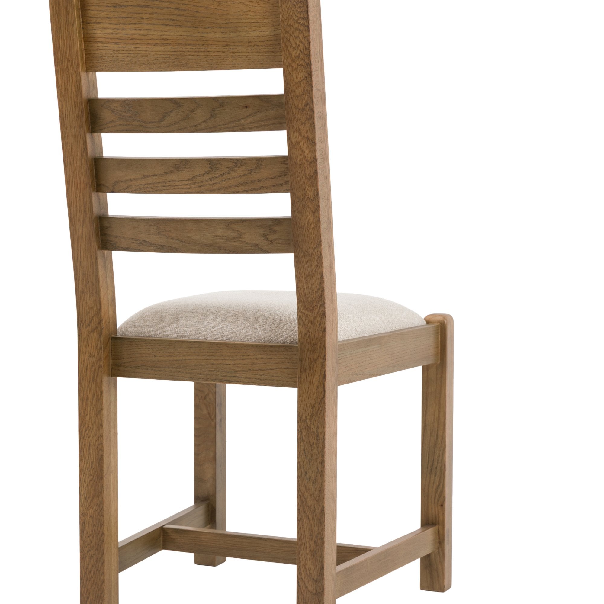 Back 3/4 view of a single oak ladder-back dining chair with a cream seat.
