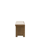 A side view of the wooden storage bench with a cushioned top on a white background.