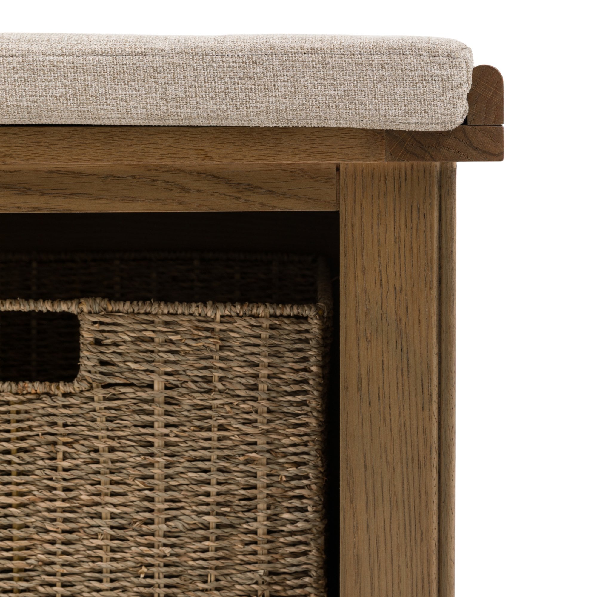 A close-up of the side of the wooden storage bench showing a wicker basket.