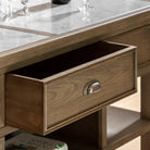 Close-up of an open drawer on the rustic kitchen island, highlighting the handle.