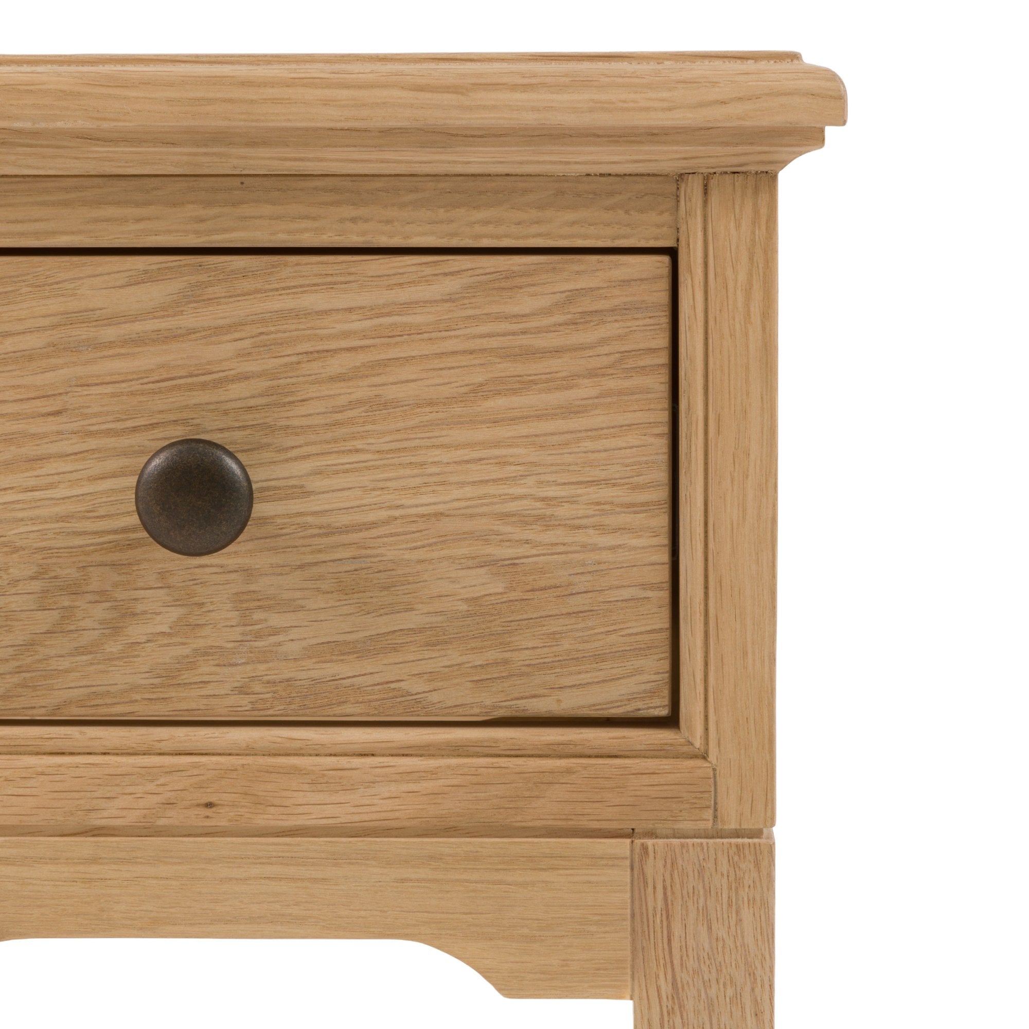 The corner of a bedside table.