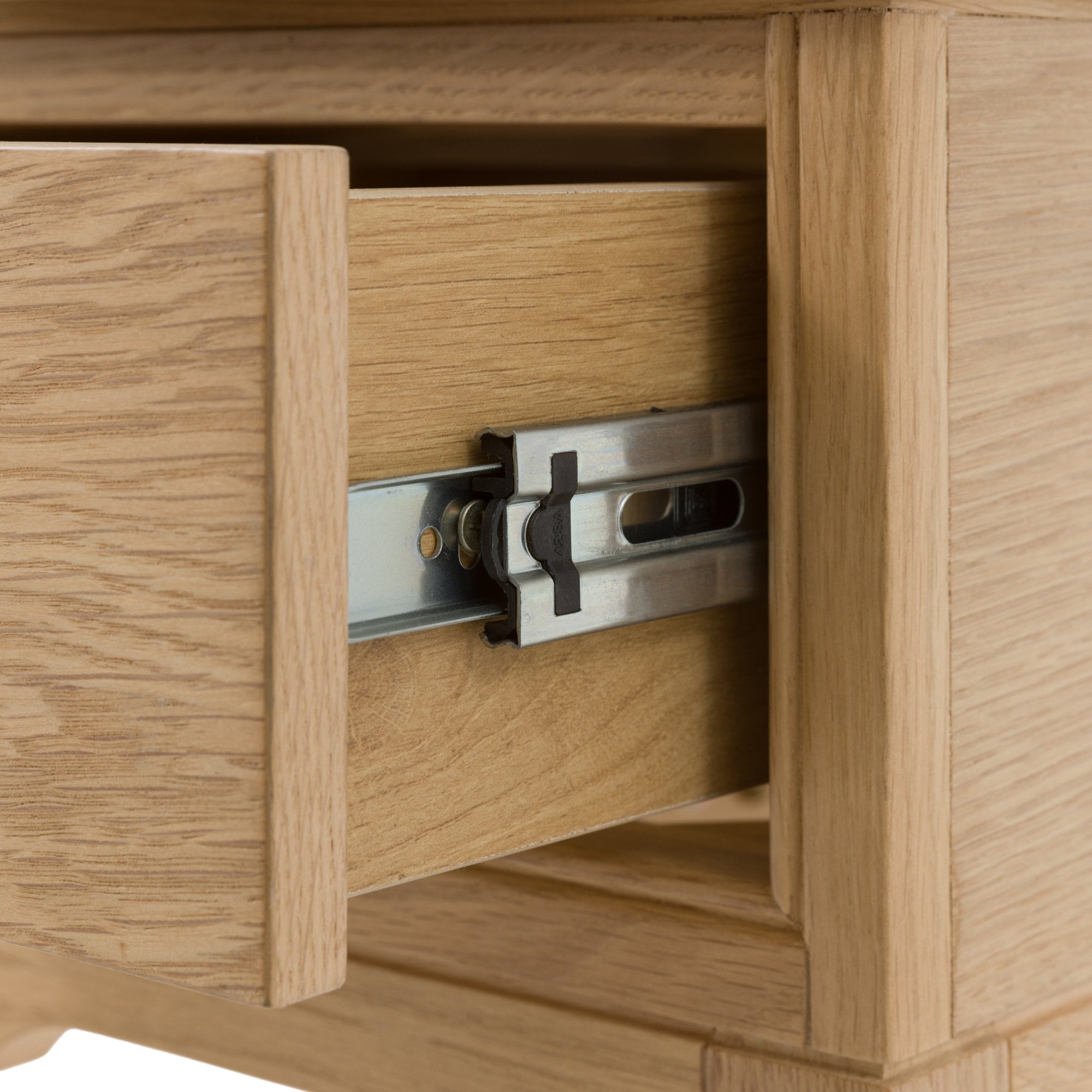 The detail of an open drawer of a bedside table.