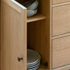 The internal storage space of the large wooden sideboard.