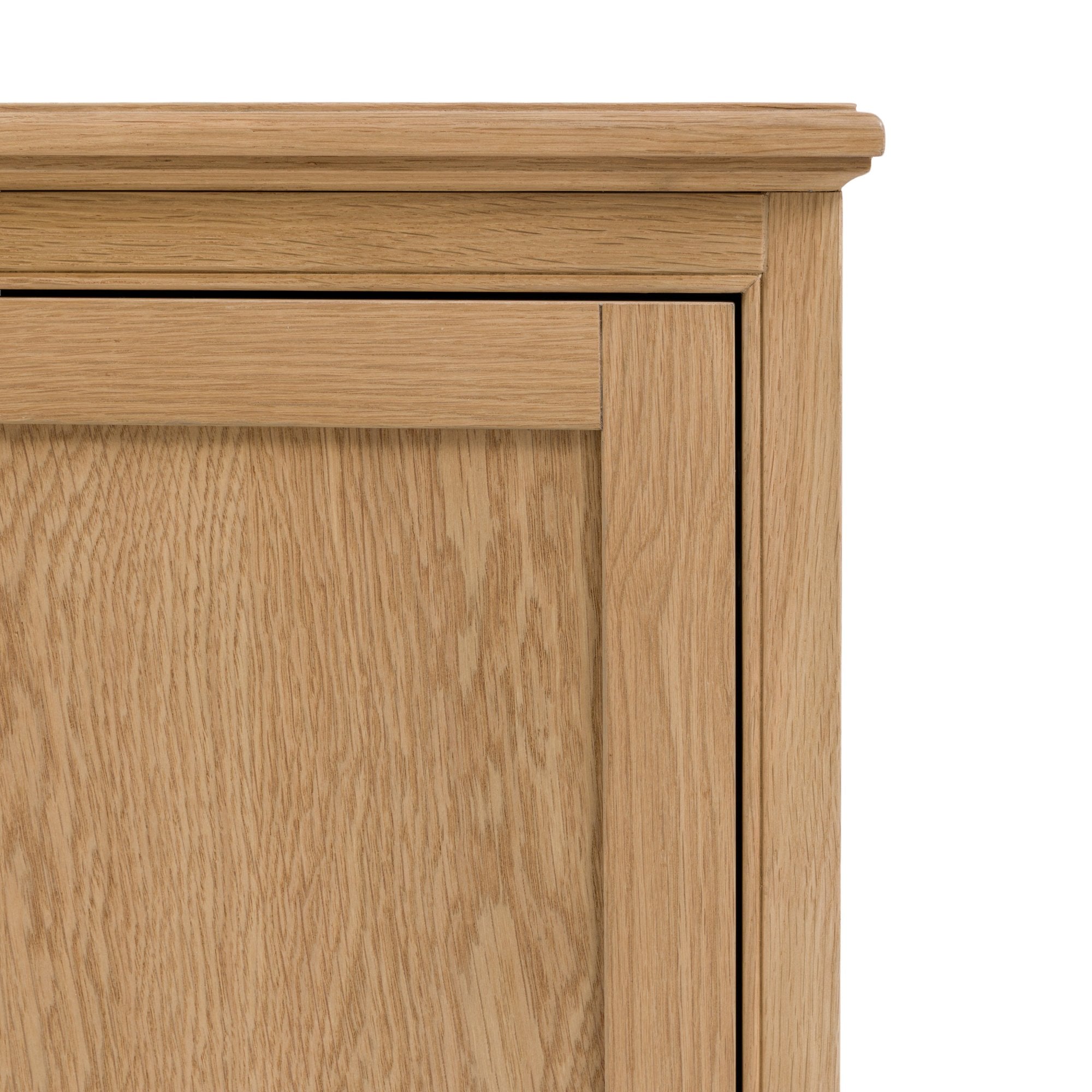 A close-up of the upper left corner of the wooden sideboard.