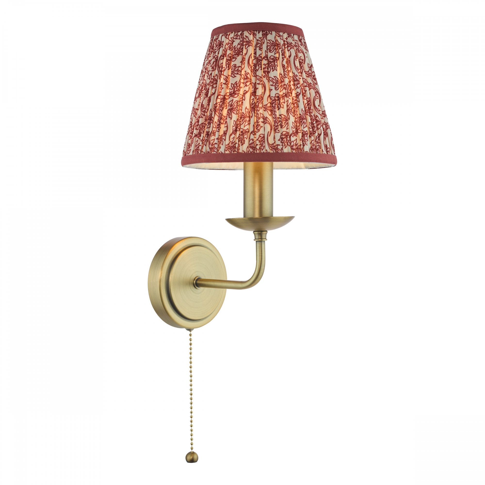 A brass wall light with a red patterned shade and a pull cord switch.