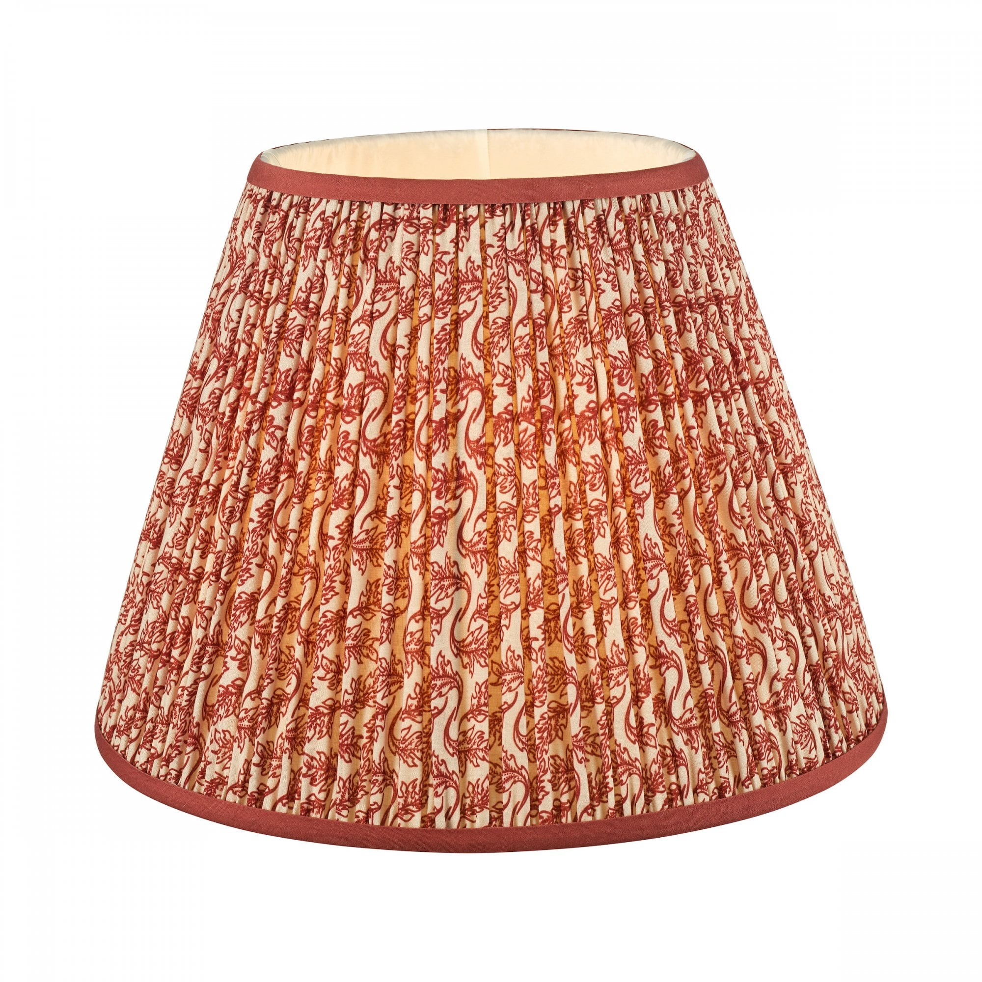 A pleated red and white patterned lamp shade with a solid red trim.