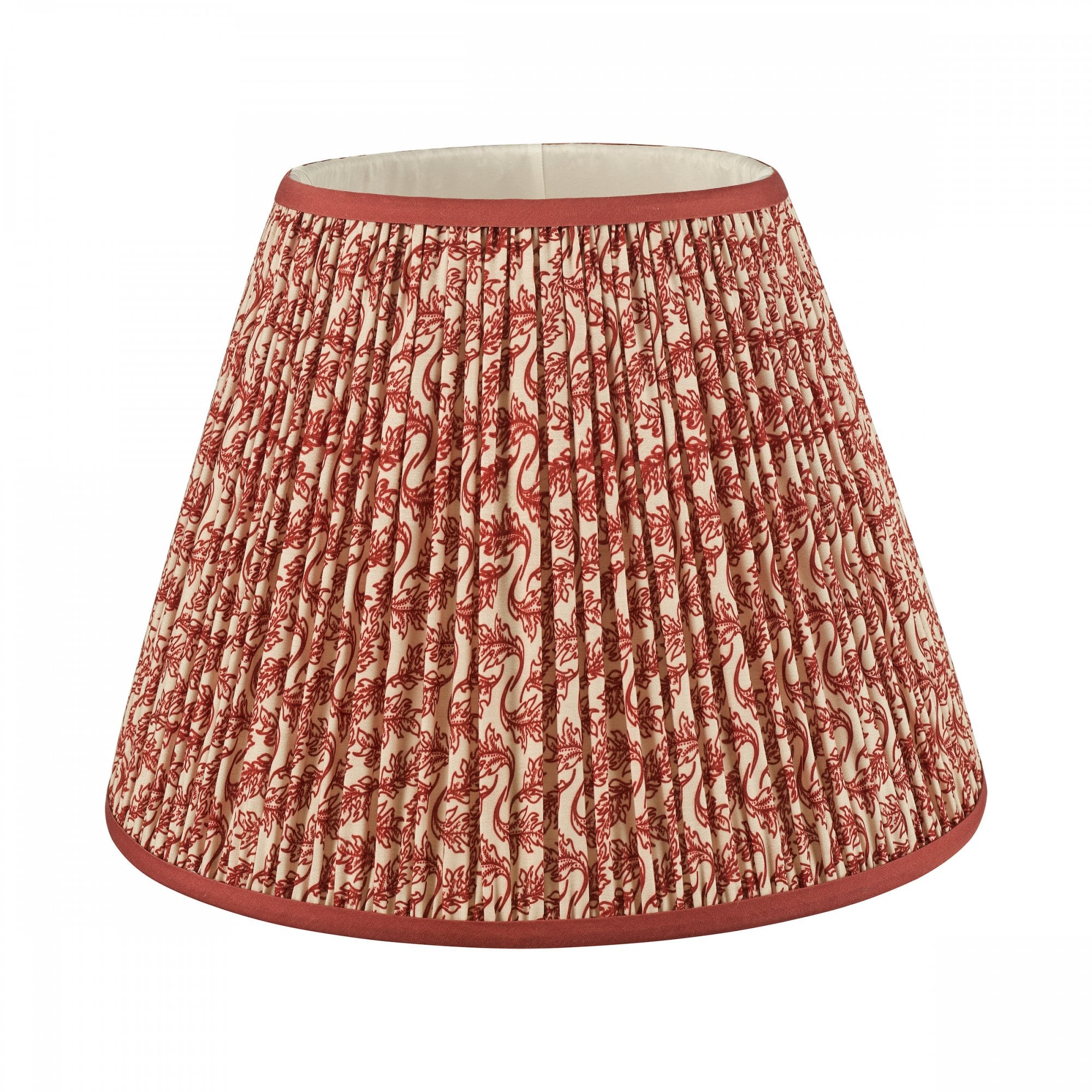 A pleated red and white patterned lamp shade with a solid red trim.