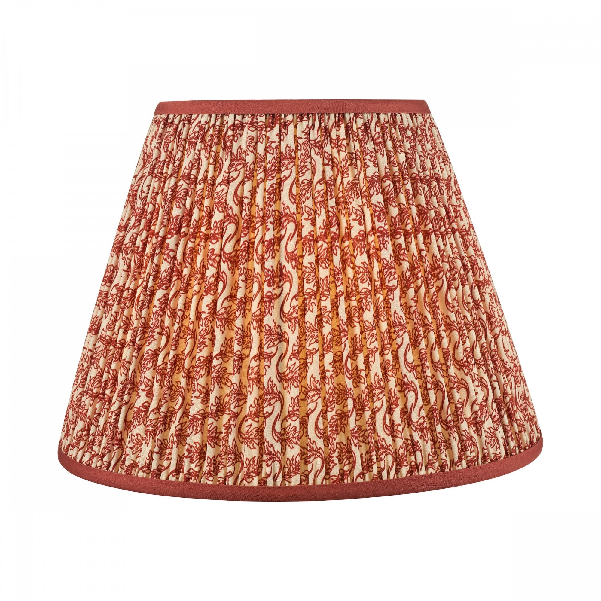 A pleated red and white patterned lamp shade with a solid red trim.