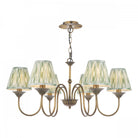 A brass chandelier with six green pleated shades.