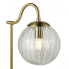 Close-up of the lamp's clear ribbed glass shade and brass fitting.