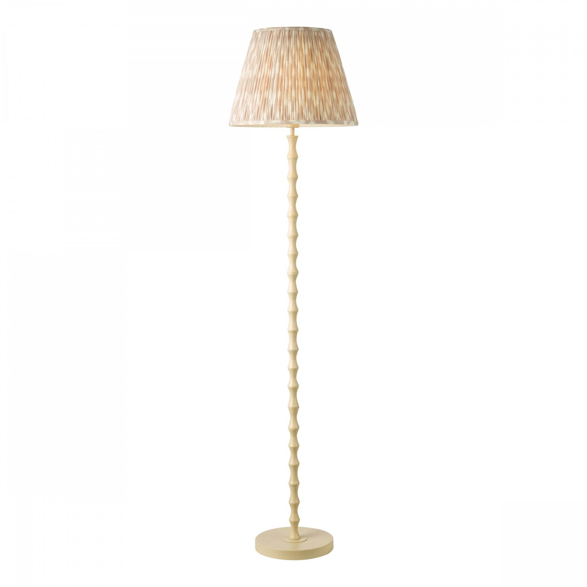 A cream beaded floor lamp with a matching pleated tapered drum shade to diffuse light.