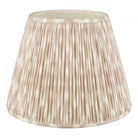 A white and beige pleated tapered drum lamp shade for table lamps or floor lamps.
