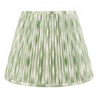 Green and white pleated lampshade.