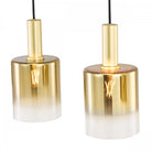 Two gold and clear glass pendant lights with visible filament bulbs against a white background.