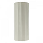 A white fluted wall light with a textured, ribbed surface, ideal for modern interiors.